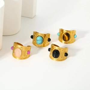 Detail of 18k gold plated stainless steel rings with large natural oval gemstones and hammered texture