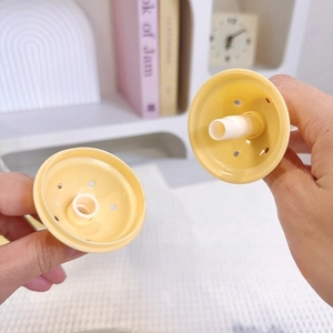 Detail of yellow star-shaped tea infuser with micro-perforations for loose leaf tea