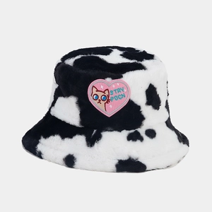 Detailed close-up of cow print bucket hat with pink heart cat embroidery patch