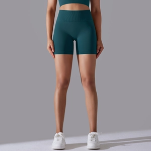 Close-up of high-waisted teal seamless yoga shorts with tummy control and firming fabric