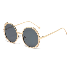 Round pearl oversized metal sunglasses for women with golden frames and dark grey lenses