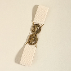 Detail of beige elastic belt featuring vintage embossed gold metal buckles on textile