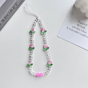 Close-up of pink tulip and clear beaded phone strap charm on a white background