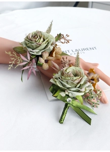 Detail of vintage green rose boutonniere and wrist corsage set with delicate berries