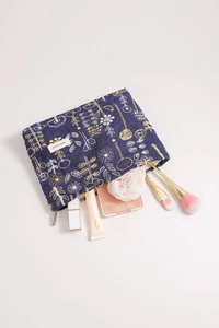Detailed embroidery of gold and white flowers on a dark blue fabric makeup bag