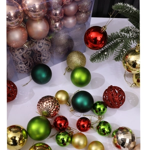 Detail of Christmas balls in various finishes and sizes with a festive pine branch display