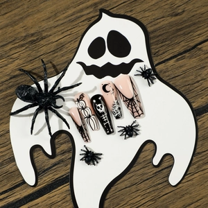 Halloween coffin press-on nails with spider web, skull and pumpkin art on ghost board