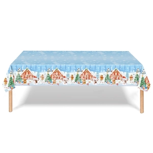 Detail view of snowflake tablecloth featuring cute gingerbread houses and snowmen