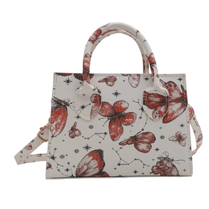White structured handbag featuring a red butterfly and constellation print with gold hardware