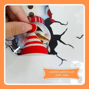 Detail showing double-sided snowman window sticker being peeled from the backing paper