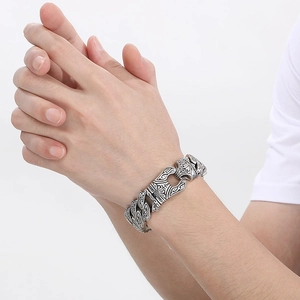Men's retro stainless steel chain bracelet with embossed vine pattern shown on wrist