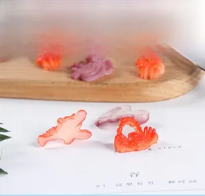 Macro view of miniature PVC crab, lobster and octopus seafood figurines for DIY crafts