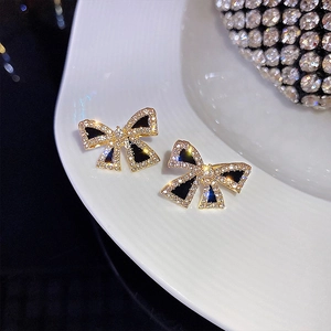 Elegant S925 silver golden bow earrings with black enamel and sparkling crystals