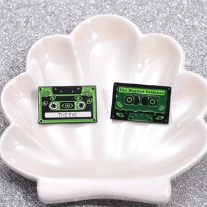 Creative green cassette tape enamel pins with eye patterns from The Magnus Archives