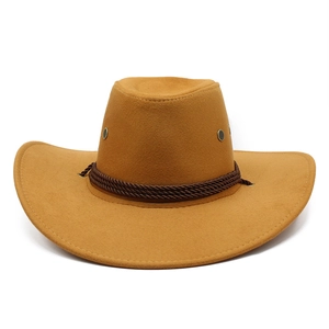 Detailed macro view of camel suede cowboy hat featuring braided trim and metal eyelets