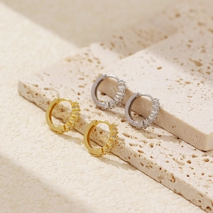 Detailed view of luxury S925 silver hoop earrings with pavé crystals in gold and silver