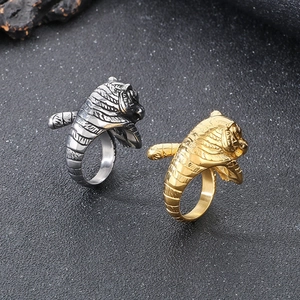 Detailed top view of gold and silver tiger head rings with punk style metallic textures