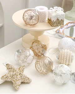 Close-up of golden and white festive Christmas ornaments with pearls and sequins