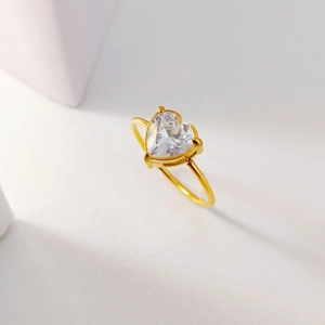 Elegant gold-plated heart-cut cubic zirconia ring on a minimalist white background