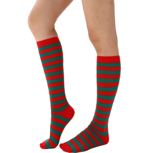 Detailed knit texture of red and green striped Christmas socks for women on leg
