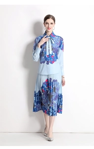 Detail of light blue floral set featuring bow-tie collar shirt and pleated midi skirt