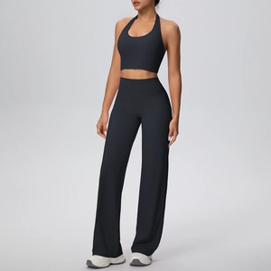 Detail of high-waisted wide leg yoga pants with halter neck sports top in navy blue