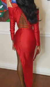 Elegant red satin long sleeve backless evening gown with criss-cross straps and high side slit