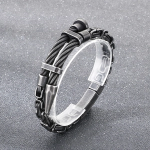 Close-up of gunmetal industrial wire cable and curb chain bracelet for men
