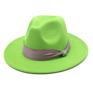 Detail of green wool fedora hat featuring purple ribbon band and rhinestone buckle