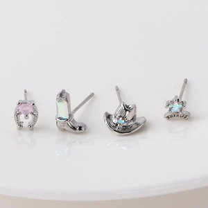 Detail of Western cowboy stud earrings set with horseshoe, boot, hat and sheriff badge