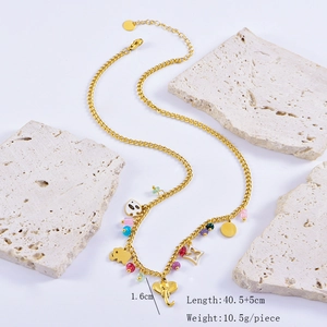 Detail shot of golden multi-charm necklace showing dimensions and elephant pendant size