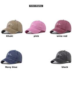 Detail of five washed cotton baseball caps with embroidered dachshund dog patterns