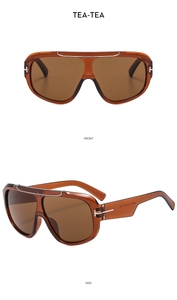 Detail view of tea-brown pilot sunglasses with transparent frames and metal T-accents