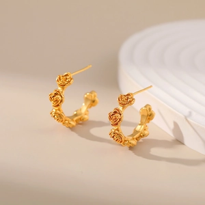 Macro detail of 18K gold plated rose flower earrings with retro matte finish and C-shape