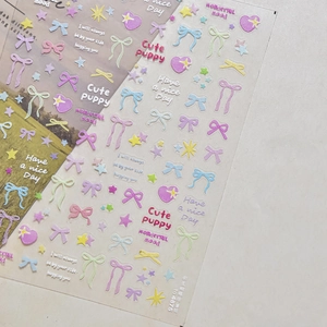 Detail view of 3D colorful bow and star nail art stickers with glitter finish