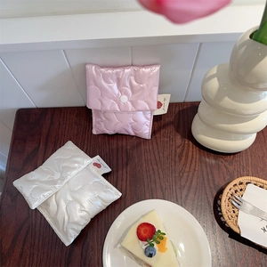 Detail of pink and white quilted heart mini storage bags with button closure