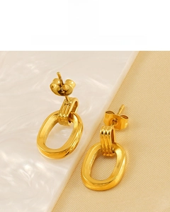 Detailed macro view of retro 18K gold plated double ring earrings with metallic finish