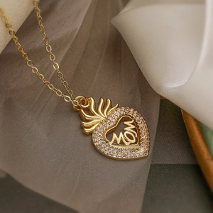 Gold heart pendant necklace with crown and MOM lettering accented with sparkling crystals