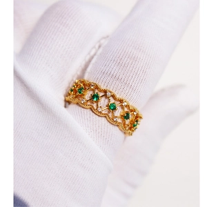 Vintage emerald zircon lace ring in hollow mesh design on a gloved finger