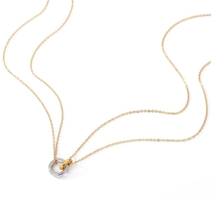 Close-up of interlocking two-tone circles on a delicate gold chain necklace