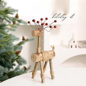 Nordic wooden reindeer Christmas ornament with natural wood grain and berry details