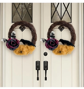 Detail of Halloween door wreath featuring black crow, purple roses, and spider on vine base
