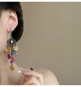 Bohemian style long drop earrings with bronze floral motifs and colorful shell-like sequins