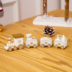 Detail of white and gold wooden Christmas train with miniature bear and snowman figurines