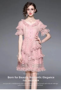 Close-up of pink layered lace dress featuring detailed V-neck and luxury embroidery