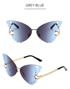 Detail of grey-blue butterfly sunglasses with gold metallic frame and carved temples