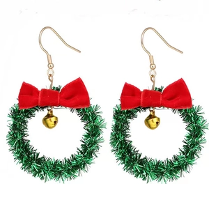 Detailed close-up of festive Christmas wreath earrings with red bow and gold bell charm