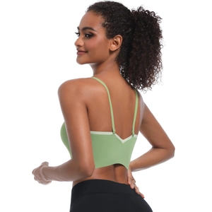 Light green sports bra with cross back straps and V-shaped cut for yoga and fitness