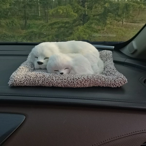 Realistic sleeping white fox plush toy on grey mat placed on a car dashboard