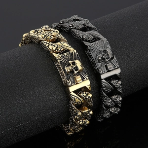 Close-up of punk style skull link bracelets in gold and black finishes with scales